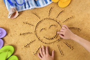 Child with smiley sun drawing